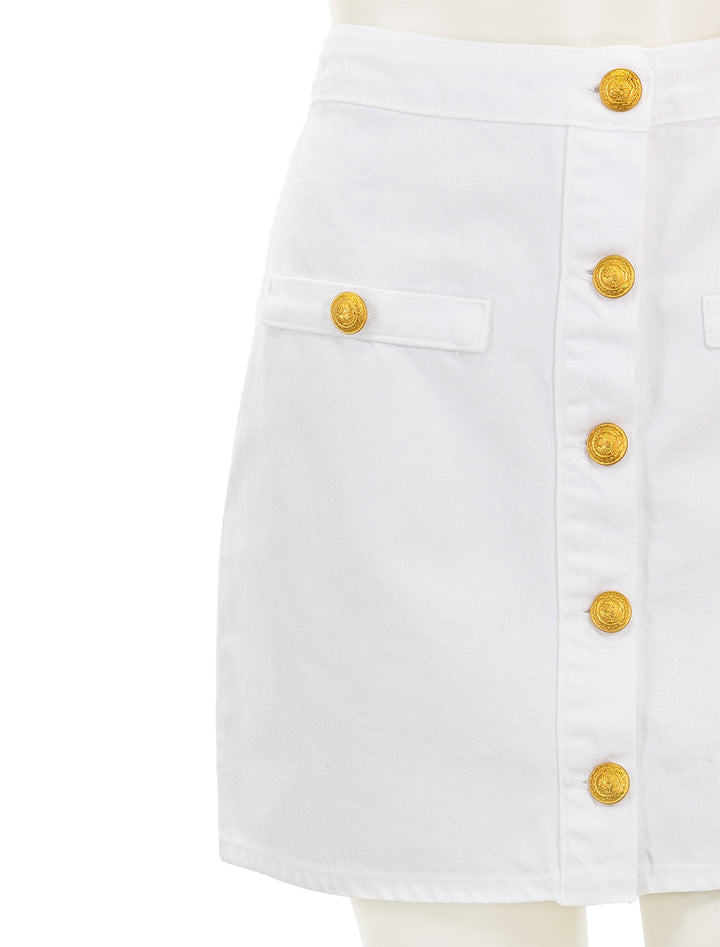 Close-up view of L'agence's kris button front mini skirt in blanc.