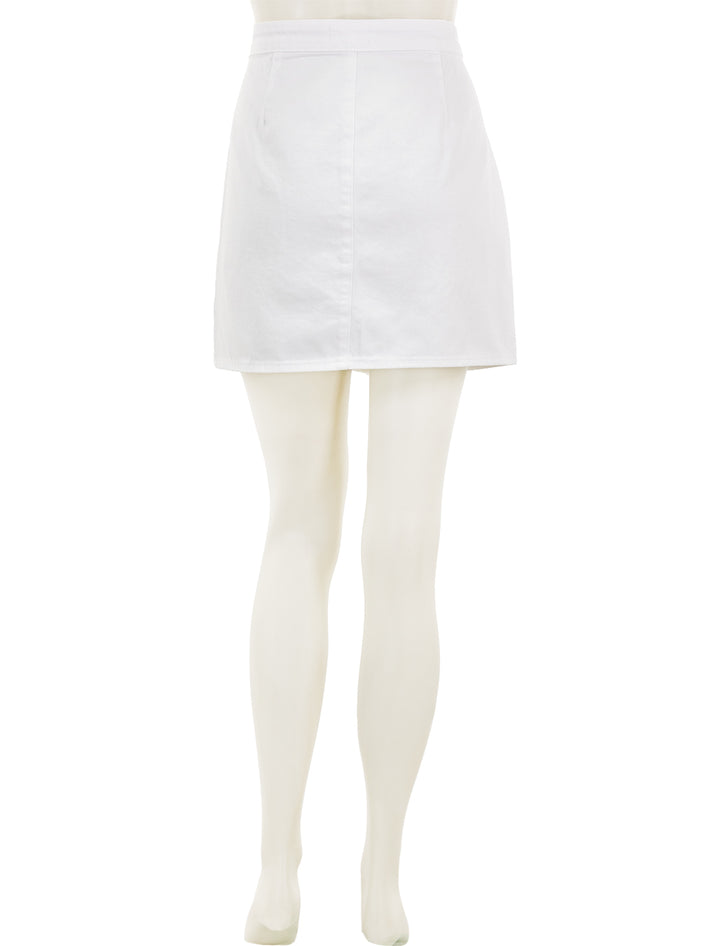 Back view of L'agence's kris button front mini skirt in blanc.