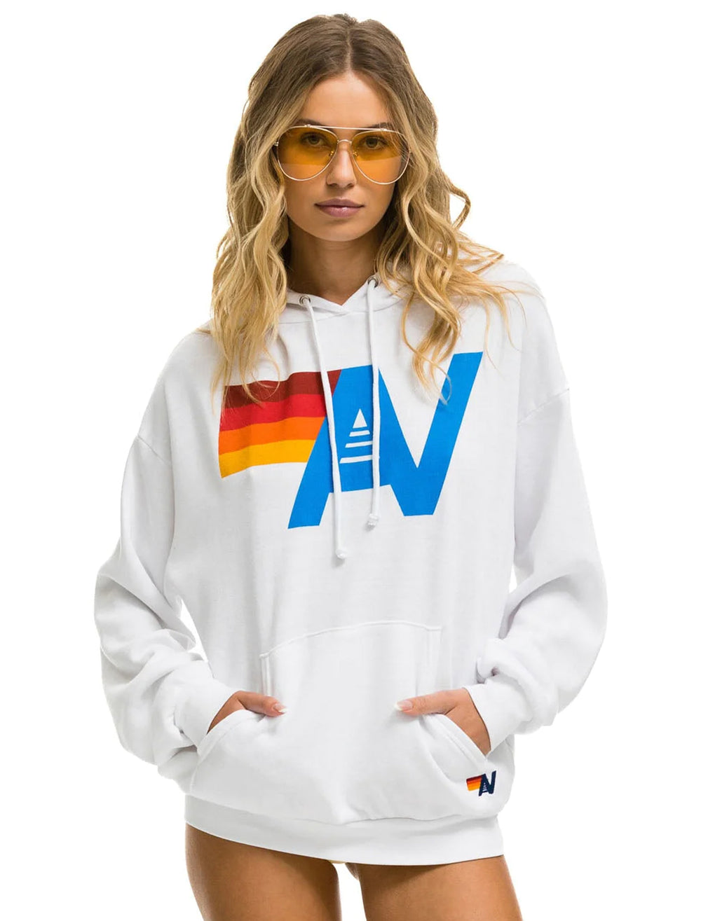 Model wearing Aviator Nation's logo pullover hoodie relaxed in white.