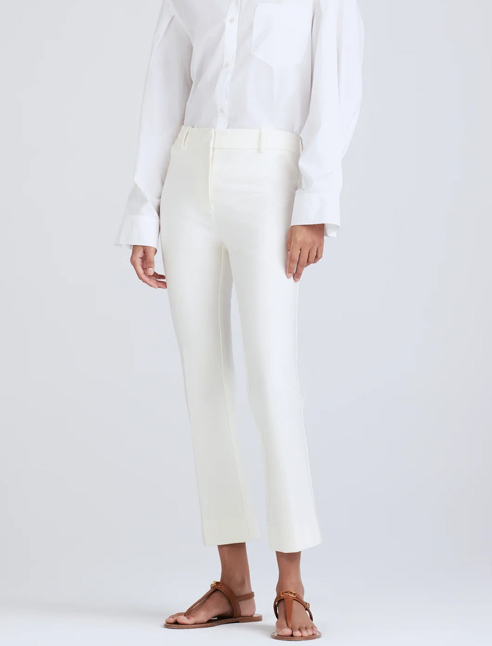 Model wearing Derek Lam 10 Crosby's crosby cropped flare trousers in white.