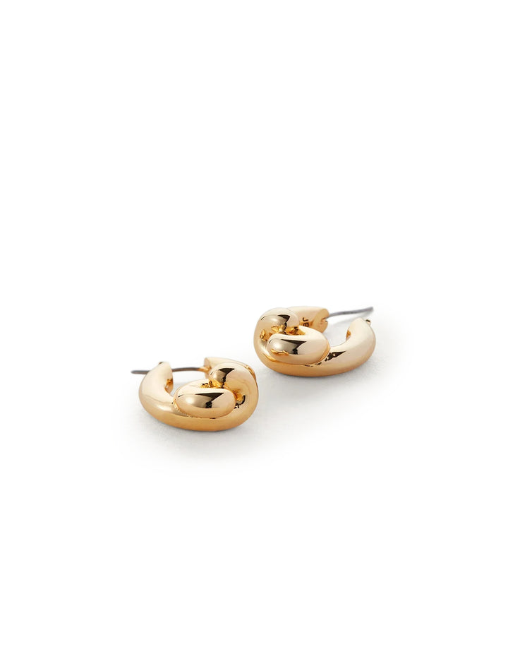 Stylized laydown of Jenny Bird's maeve small hoops in gold.