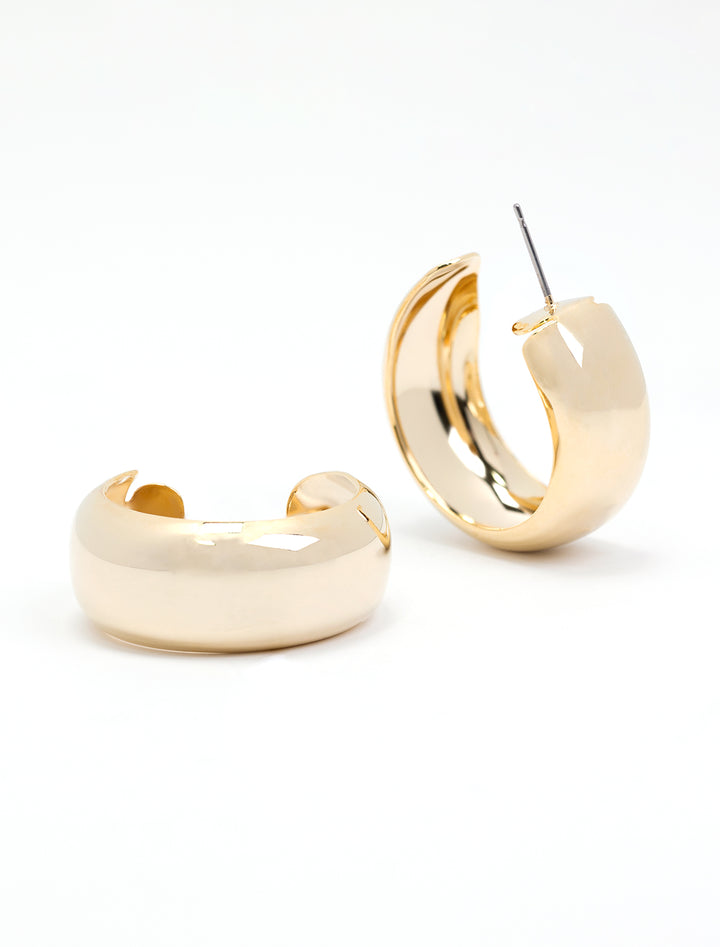 Laydown of AV Max's plain dome hoops in gold.