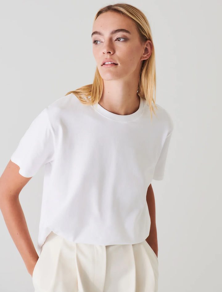 Model wearing Patrick Assaraf's short sleeve iconic boyfriend crew in white.