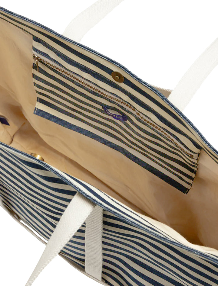 Close-up inside view of hat attack's sunhat sized traveler tote in navy stripe