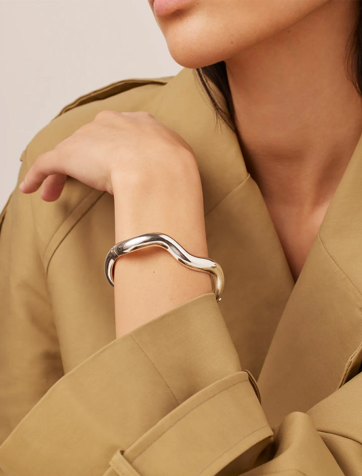 Model wearing Jenny Bird's ola bangle in silver.