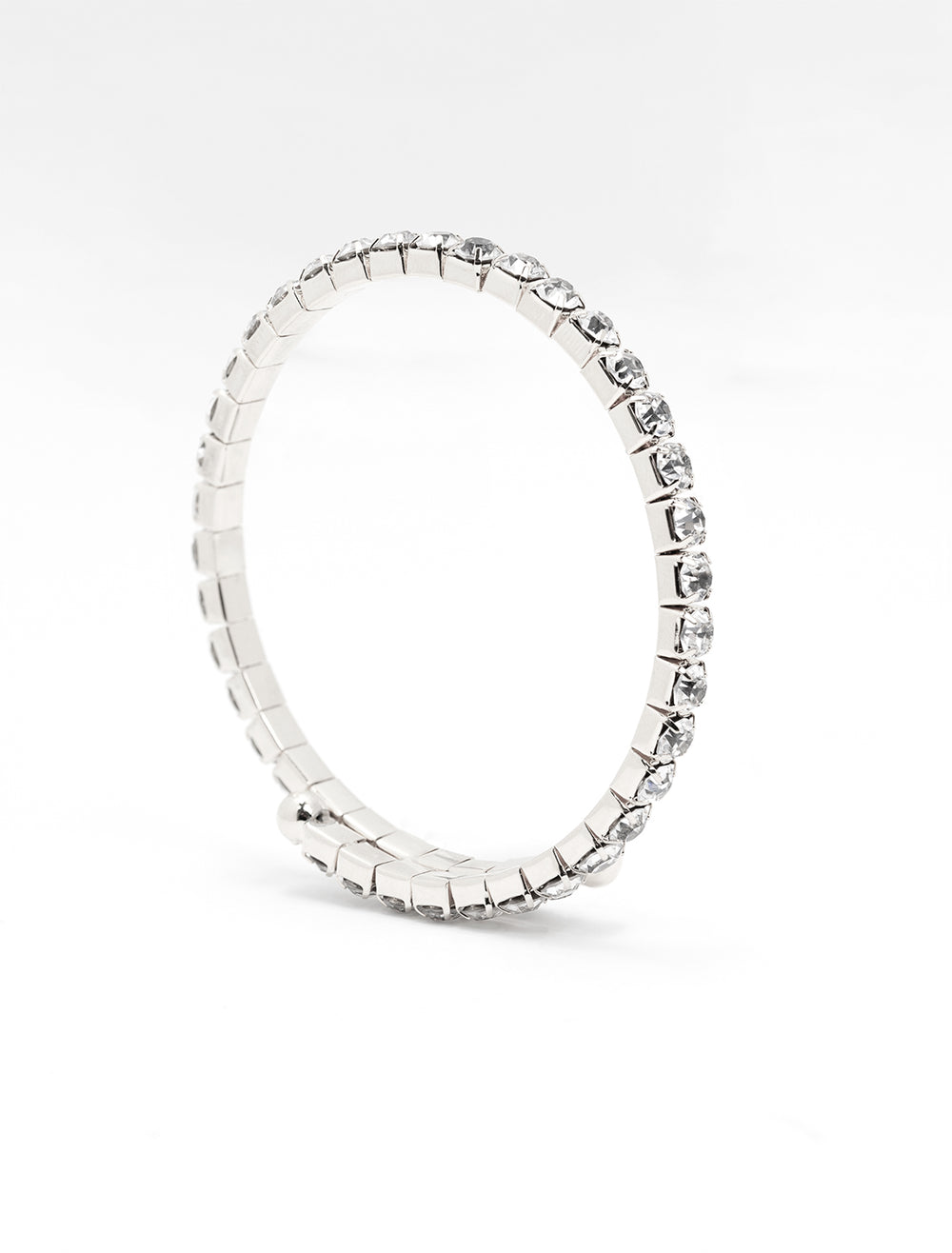 Side view of AV Max's touch of glam rhinestone coil bracelet in silver.
