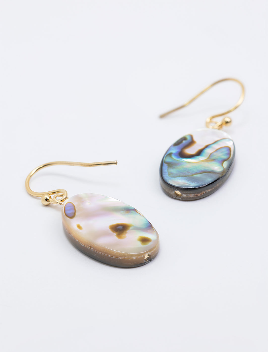 Opposite side view of AV Max's oval abalone and mother of pearl earrings.