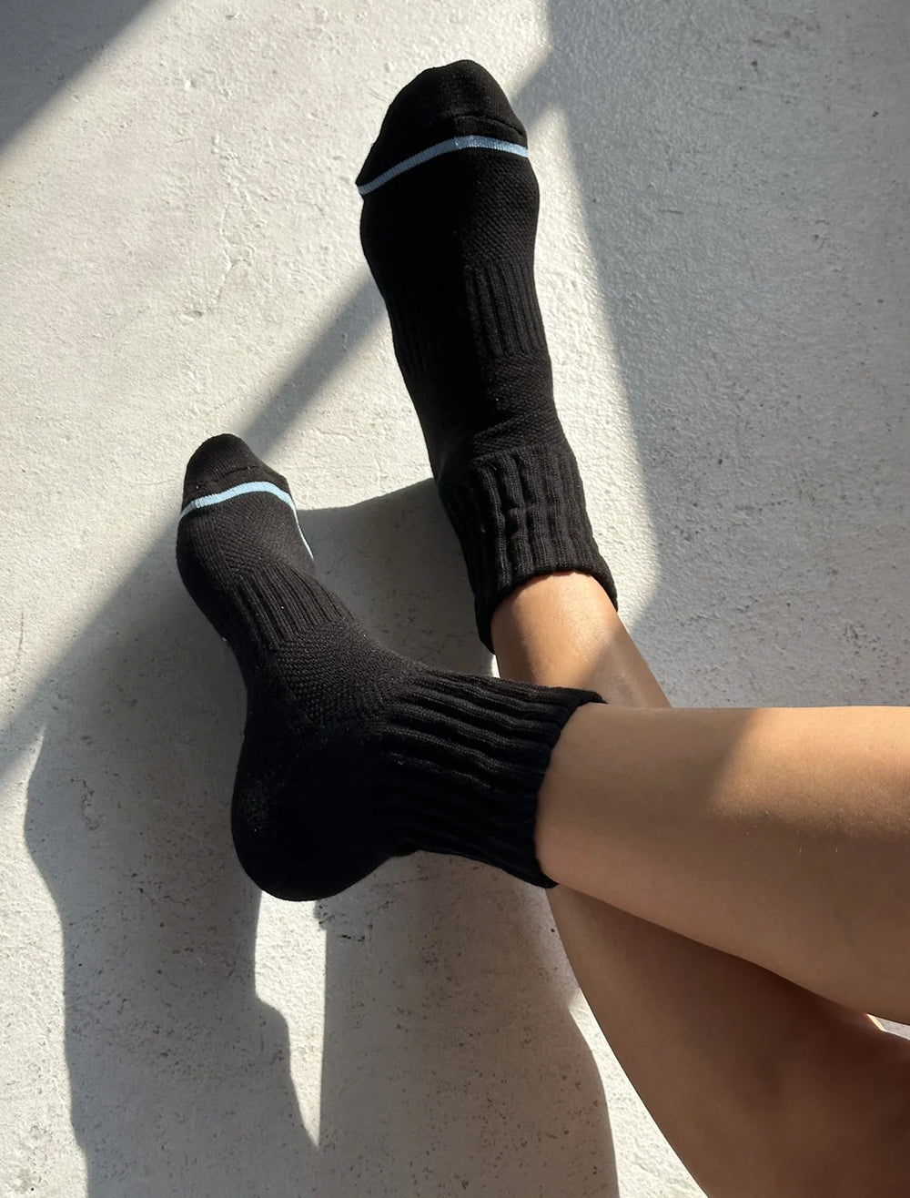 Model wearing Le Bon Shoppe's swing socks in black.