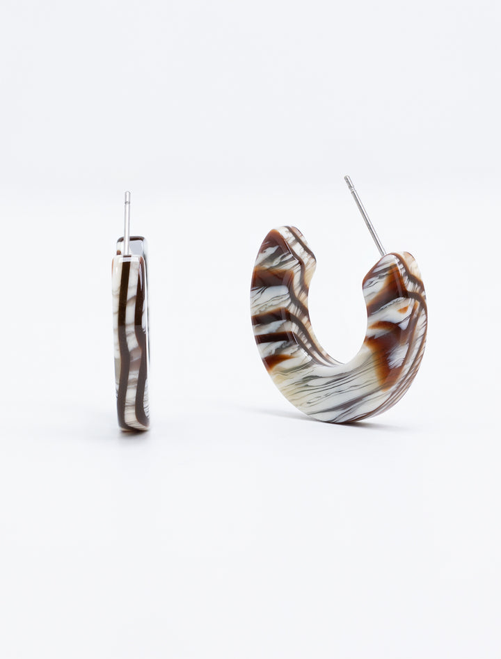 Close-up view of Nat + Noor's ray hoops in maple.
