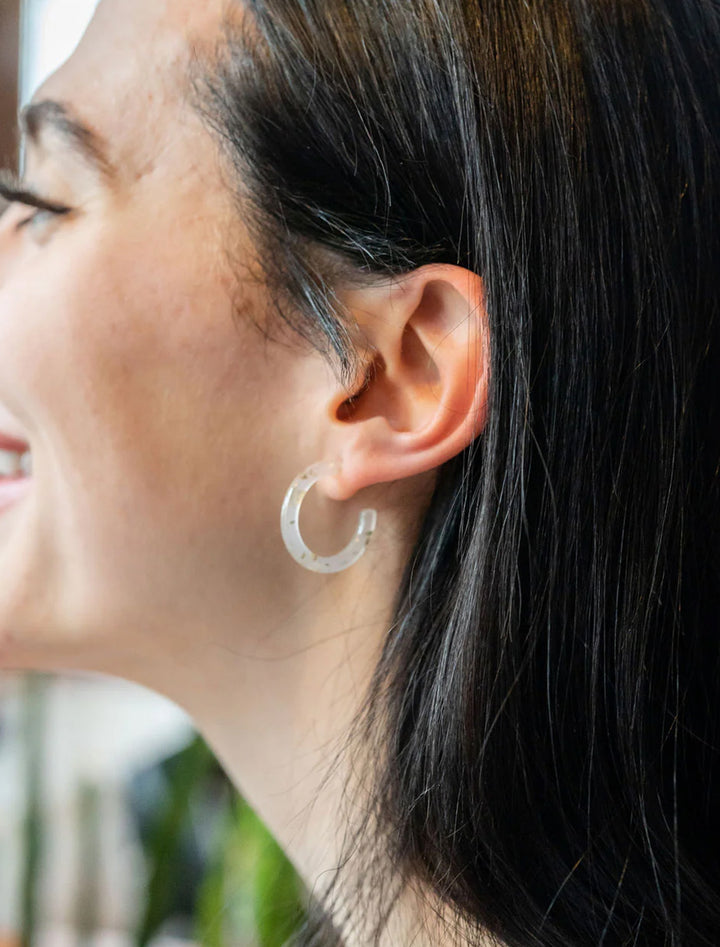 Model wearing S&S's cam mini hoops in gold flake.