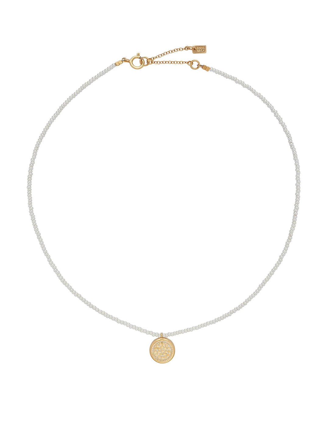 Overhead view of Anna Beck's delicate beaded pearl circle pendant necklace in gold.