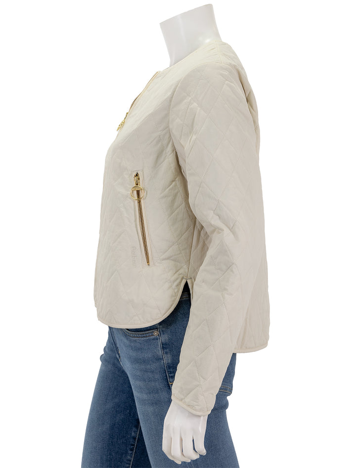 Side view of Barbour's caroline quilted jacket in antique white.