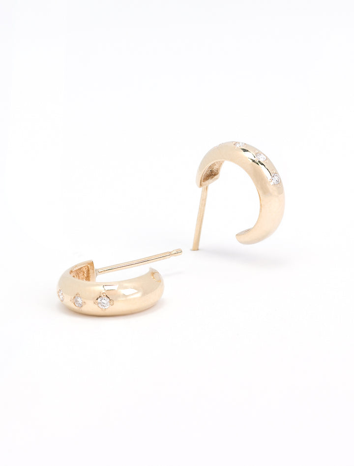 Laydown of Zoe Chicco's 14k 5 diamond chubby huggie hoops.