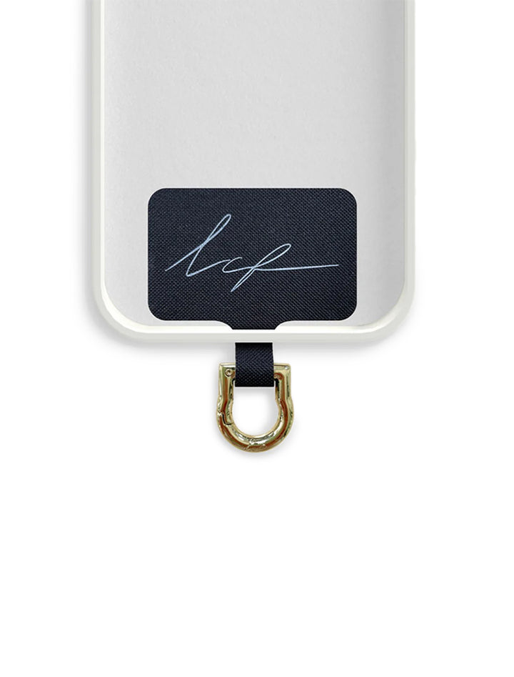 Close-up view of La Coque Francaise universal adapter in gold shown inside a phone case