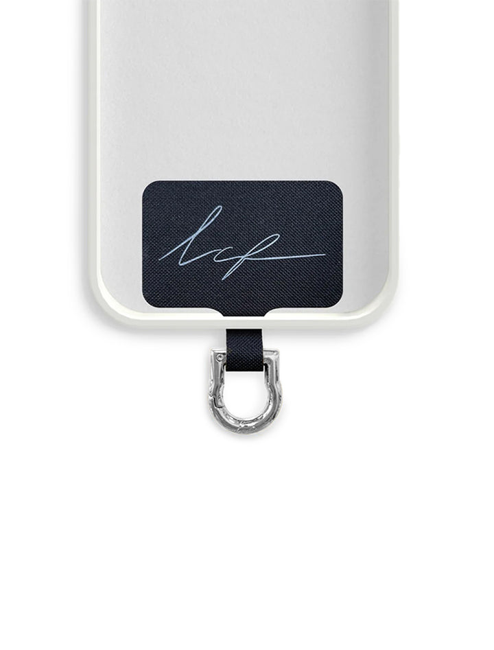 Close-up view of La Coque Francaise universal adapter in silver shown in a phone case.