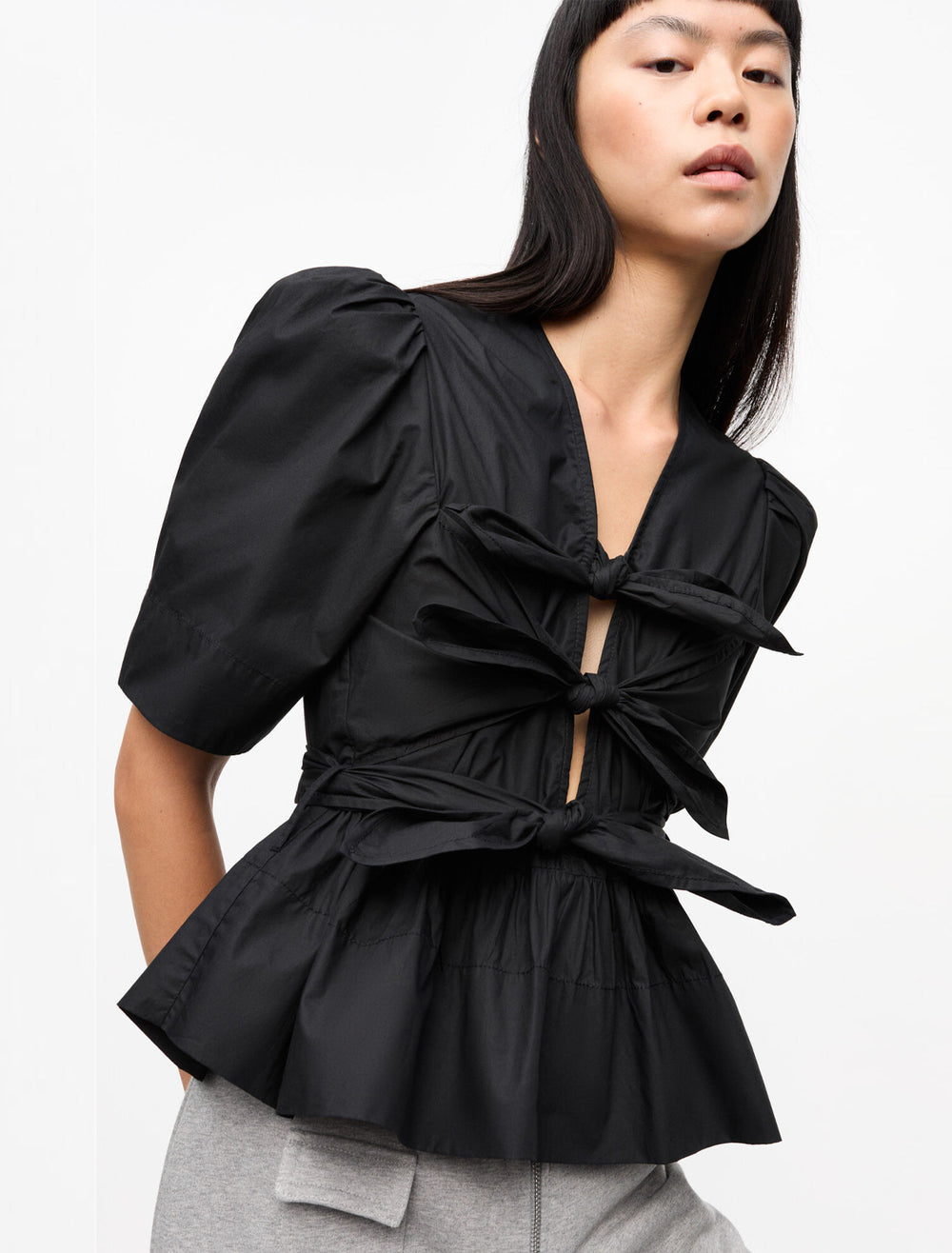 model wearing washed stretch cotton tie strap top in black