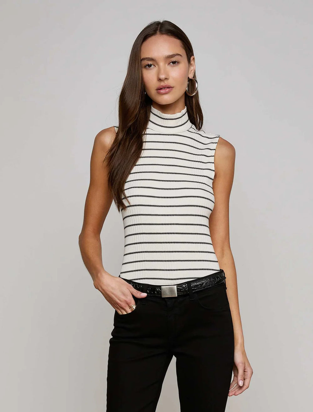 model wearing rosie sleeveless mock neck in ivory and black stripe