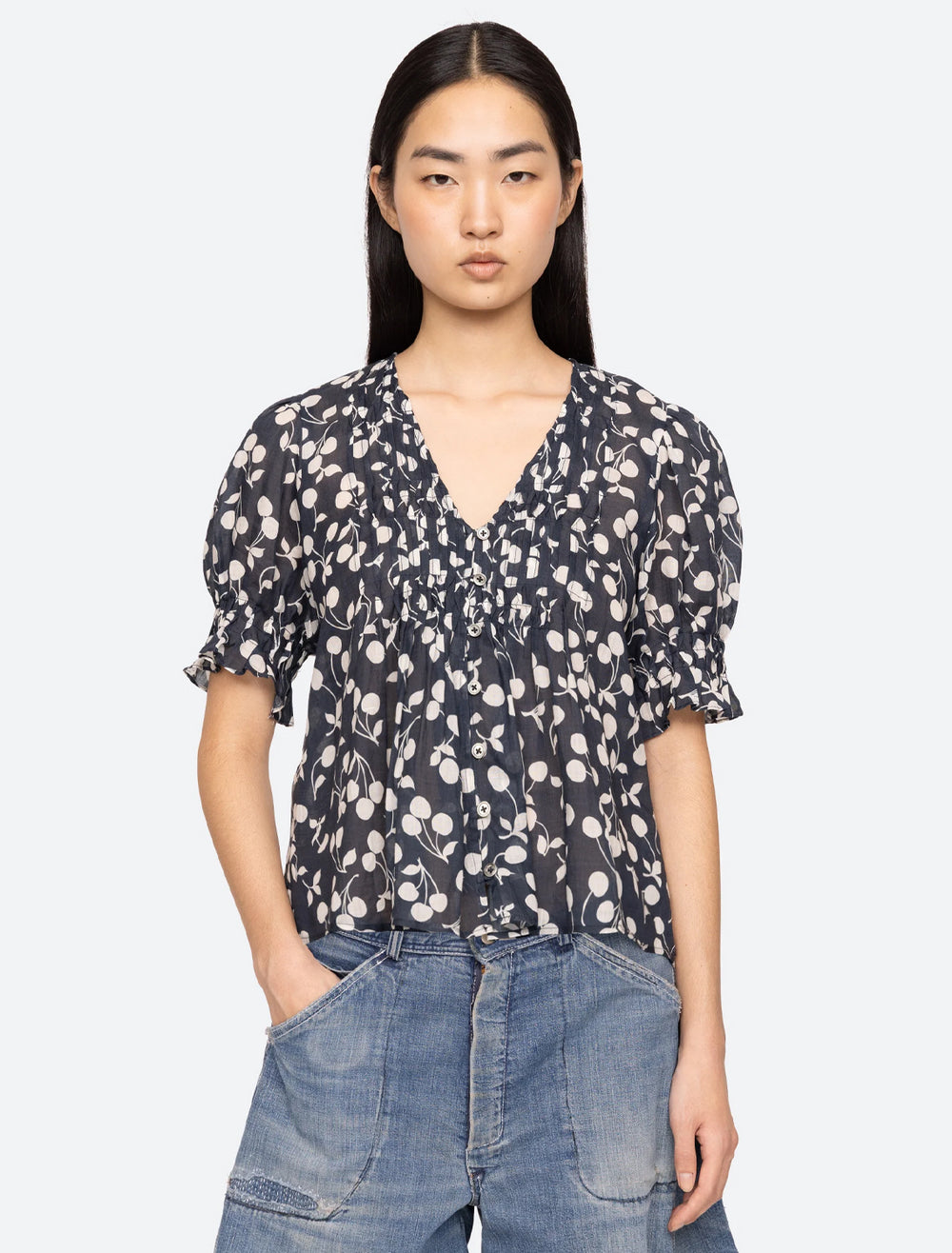 model wearing cheri print blouse in navy