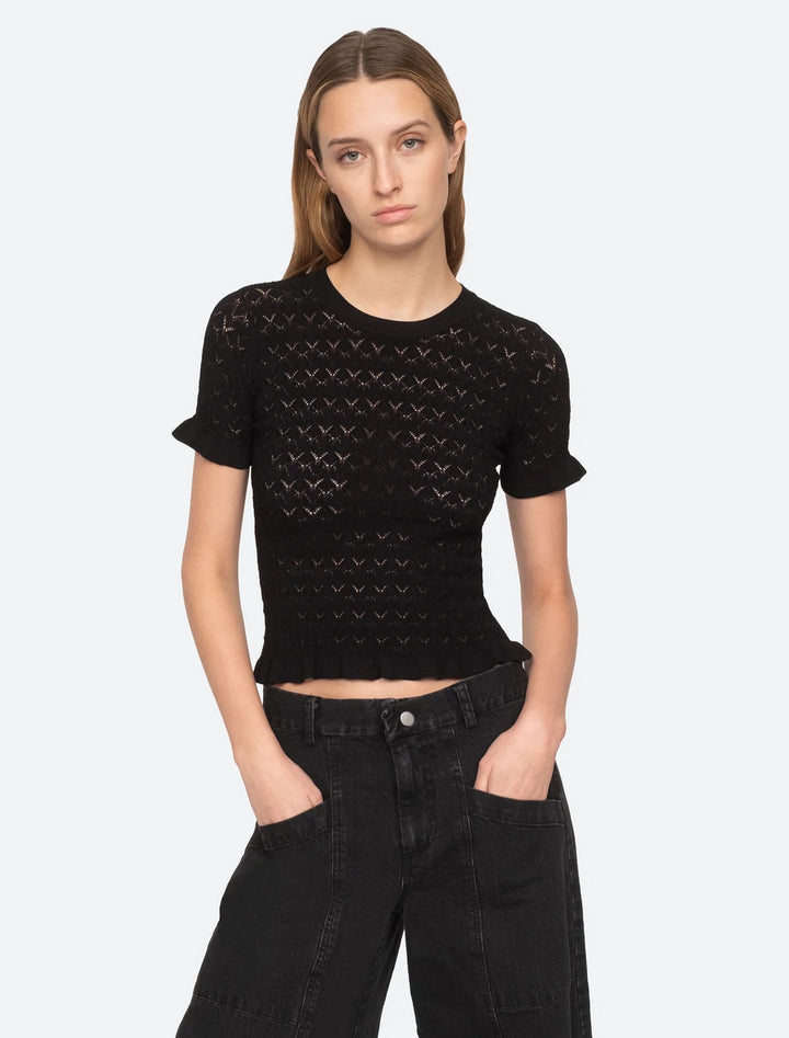 model wearing rue fine gauge knit short sleeve sweater top in black
