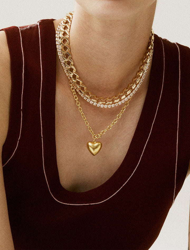 model wearing the mini puffy heart necklace