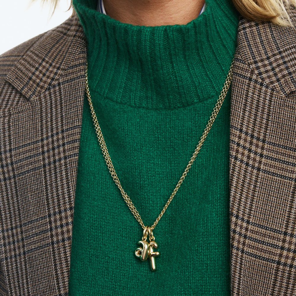 model wearing the puffy initial necklace | f