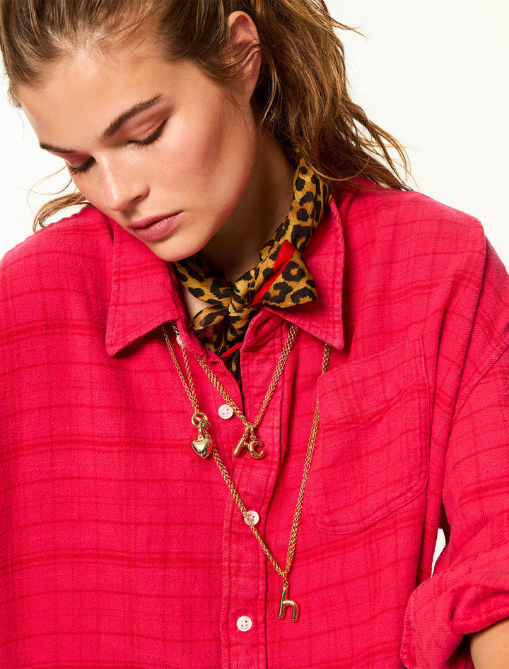 model wearing the puffy initial necklace | h