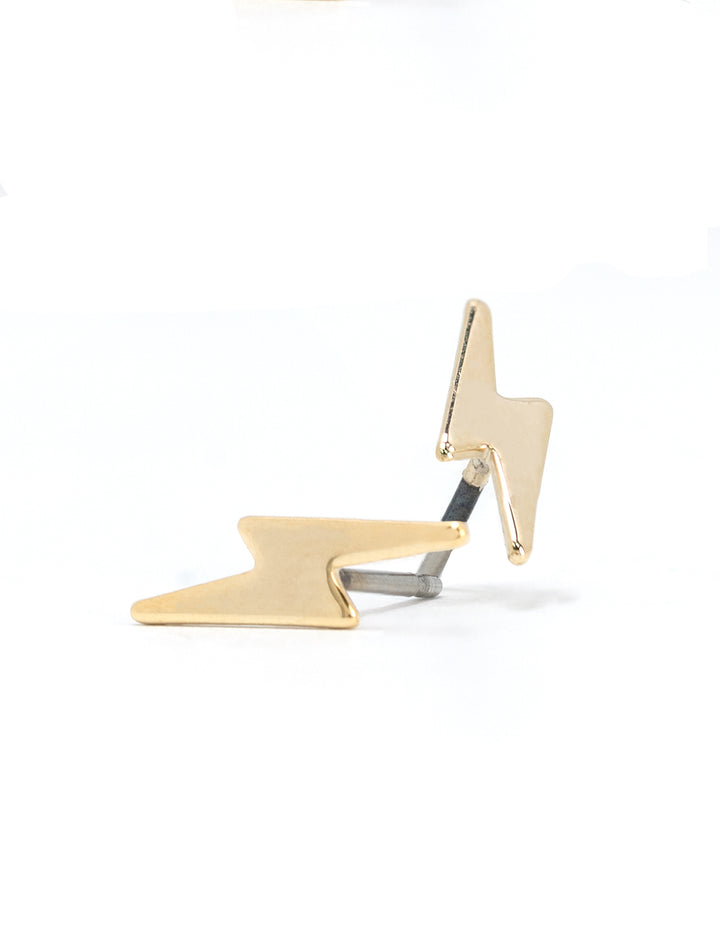 Stylized laydown of AV Max's gold lightening bolt earrings.