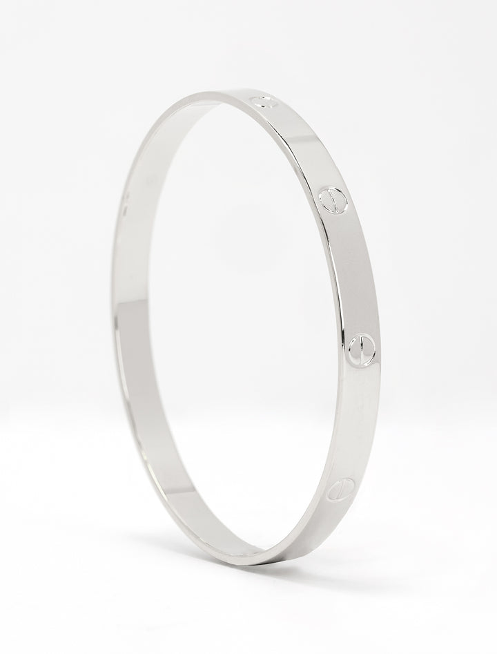 Close-up view of AV Max silver bangle with screw accents
