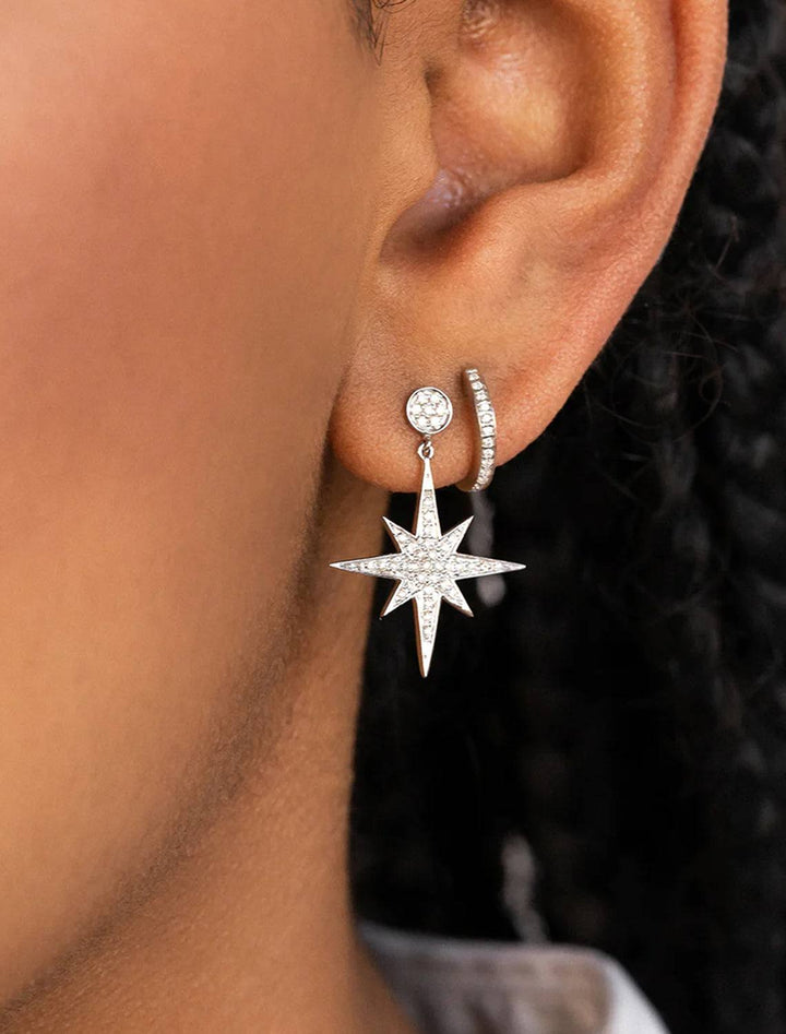 Model wearing Sydney Evan's pave huggie hoops in white gold.