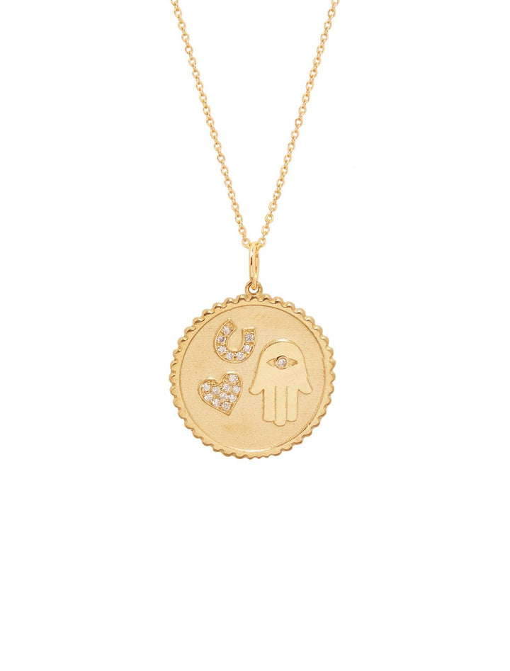 a single small luck and protection coin charm hangs from a fine 14k yellow gold chain. the charm features a heart with pave diamonds, horsehoe and  hamsa hand