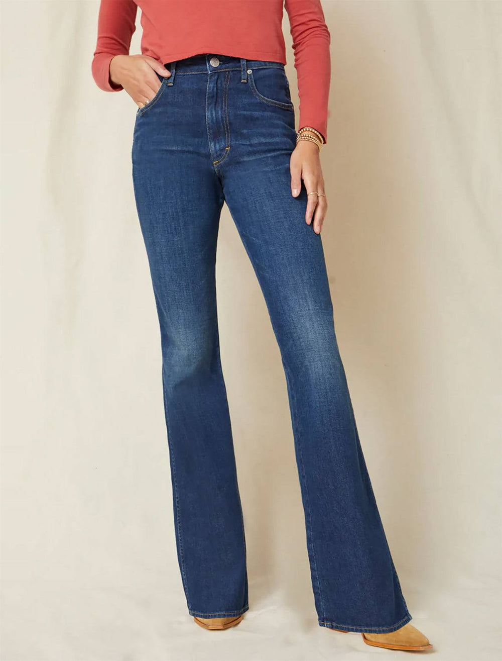 model wearing willa slim flare in grateful with a pink top and cowboy boots