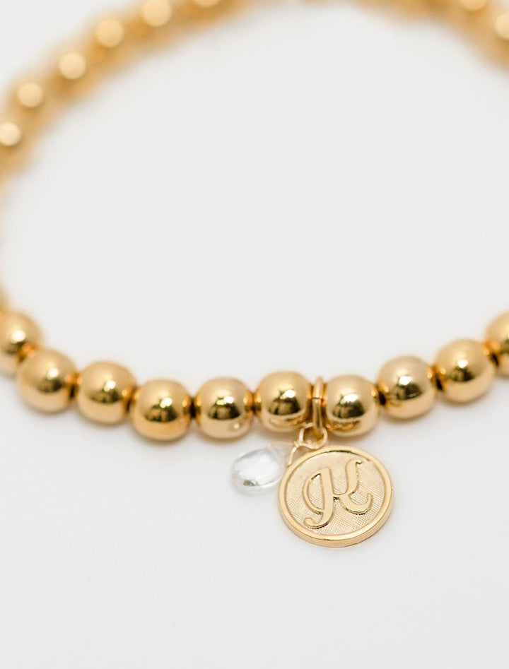 close up view of beaded monogram bracelet | K