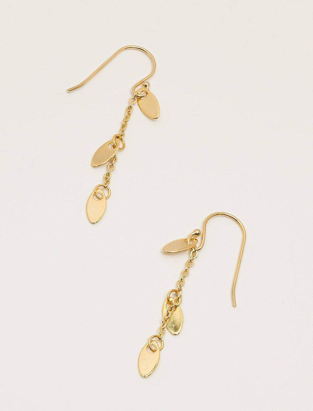 top down flat view of dainty petal earrings