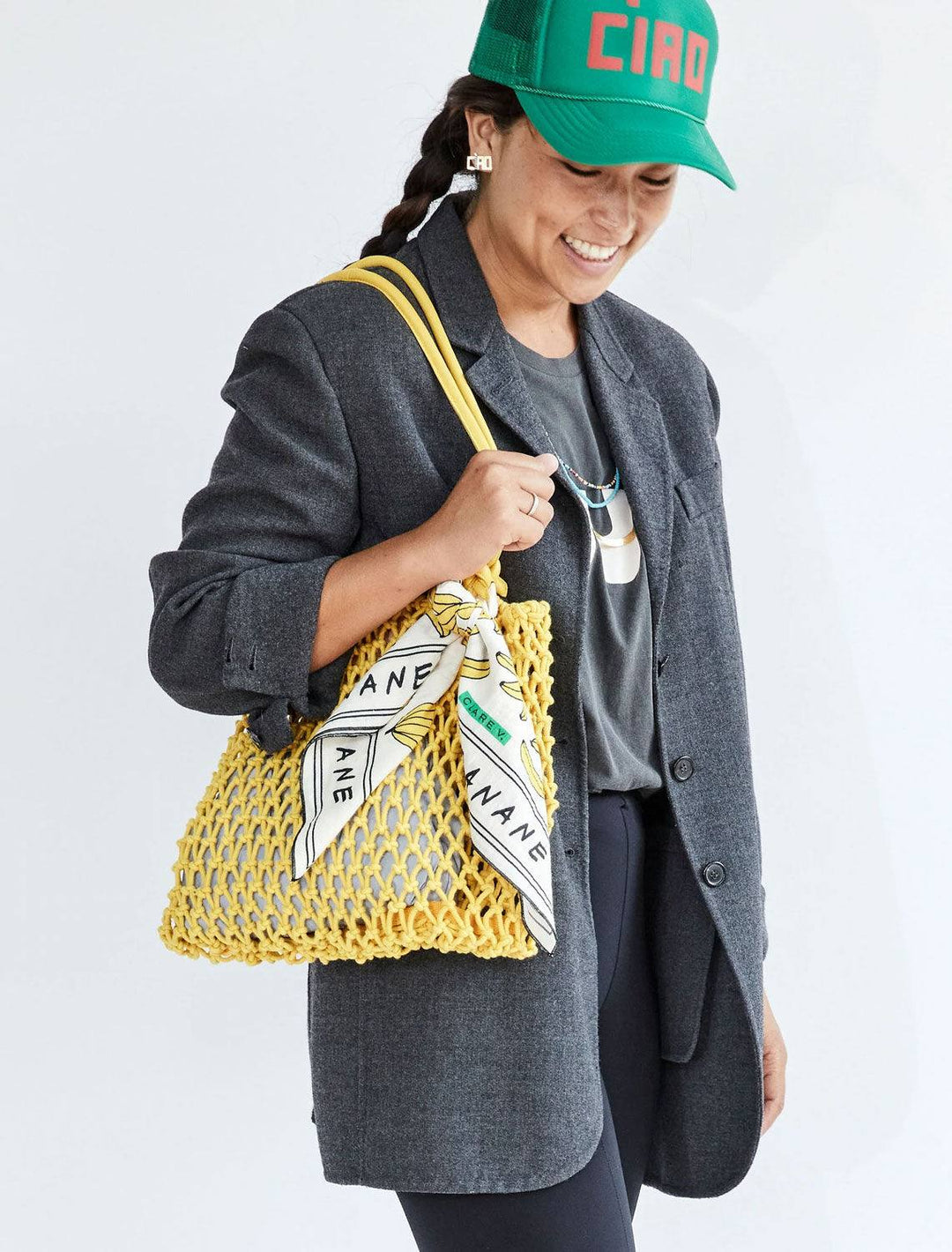 model carrying sandy tote in yellow by handles