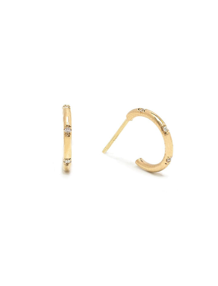 Front view of Zoe Chicco's 14k huggie hoops with bead set diamonds.