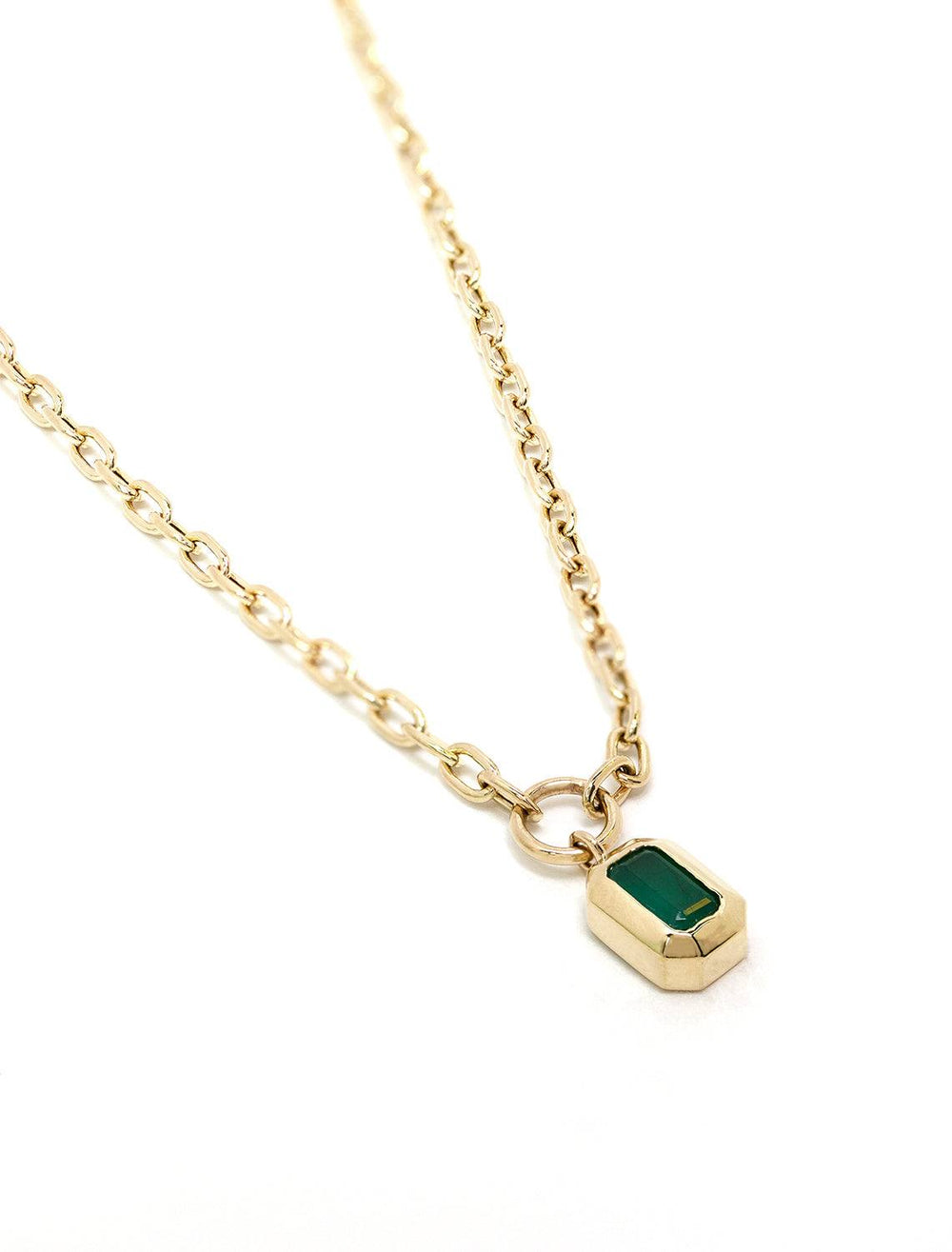 Close-up view of Zoe Chicco's 14k small link chain with bezel set emerald drop necklace.
