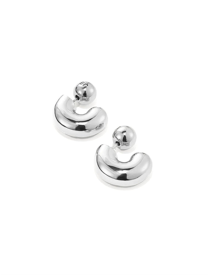 Side angle view of Jenny Bird's Small Tome Hoops in Silver Dipped Brass.
