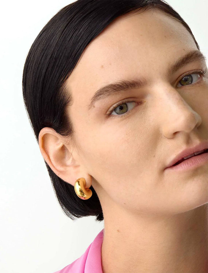 Model wearing Jenny Bird's Medium Tome Hoops in 14K Gold-Dipped Brass.