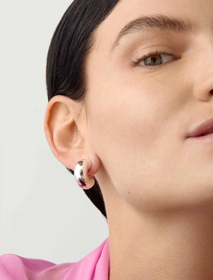 Model wearing Jenny Bird's Medium Tome Hoops in Silver Dipped Brass.