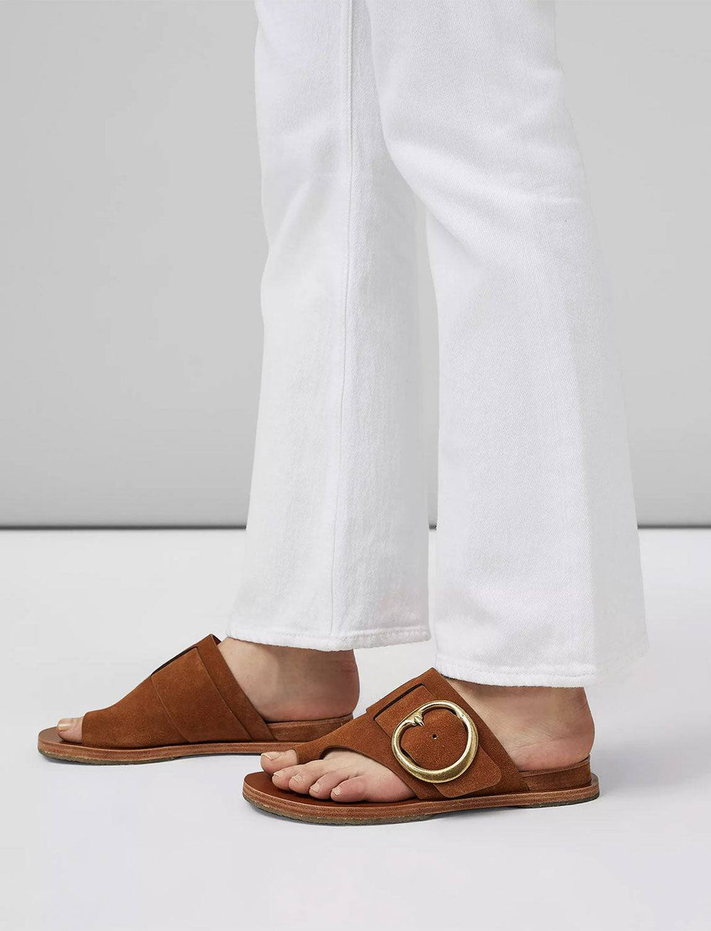 Model wearing Rag & Bone's beau buckle slide in tobacco suede.