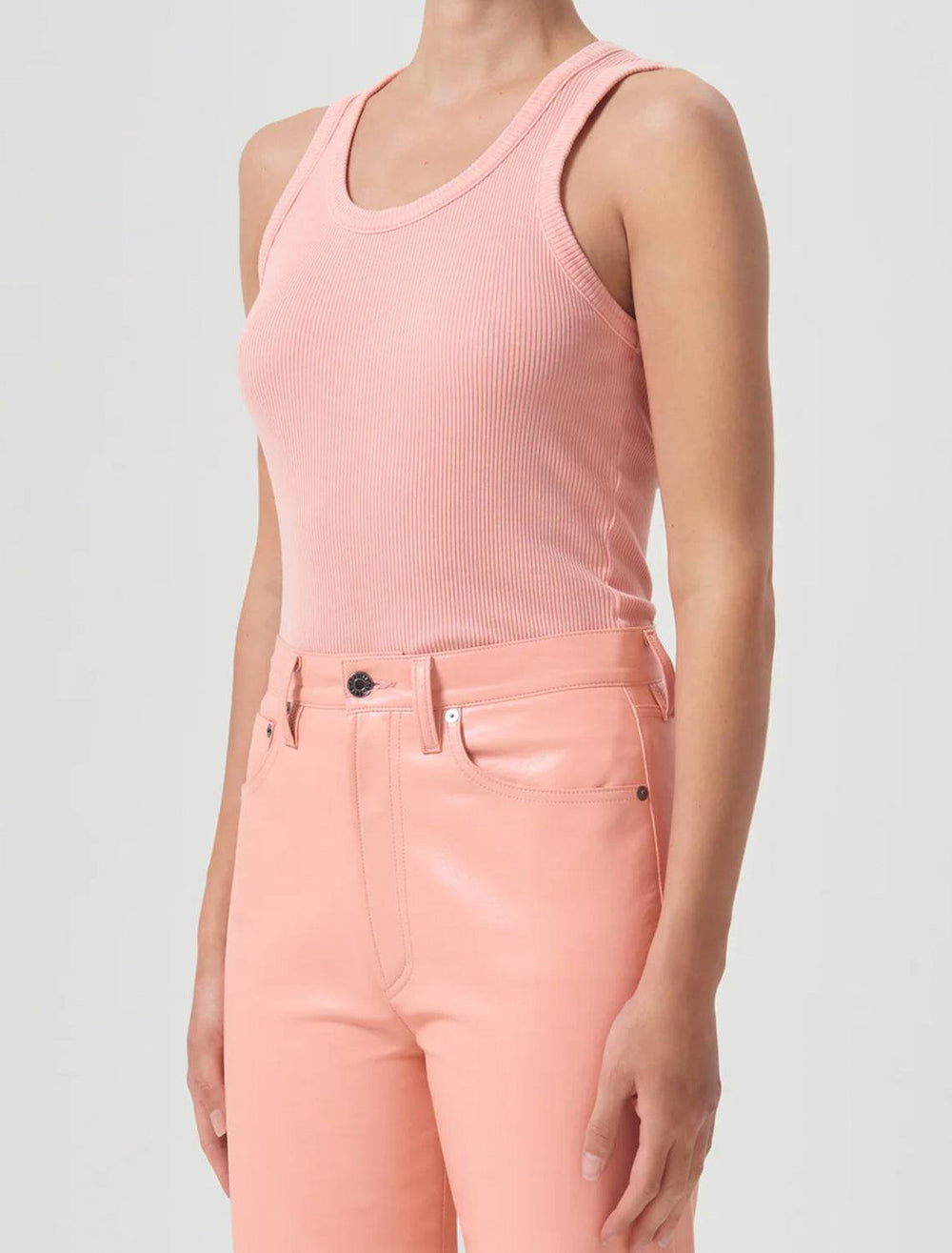 Model wearing AGOLDE's poppy tank in grapefruit.