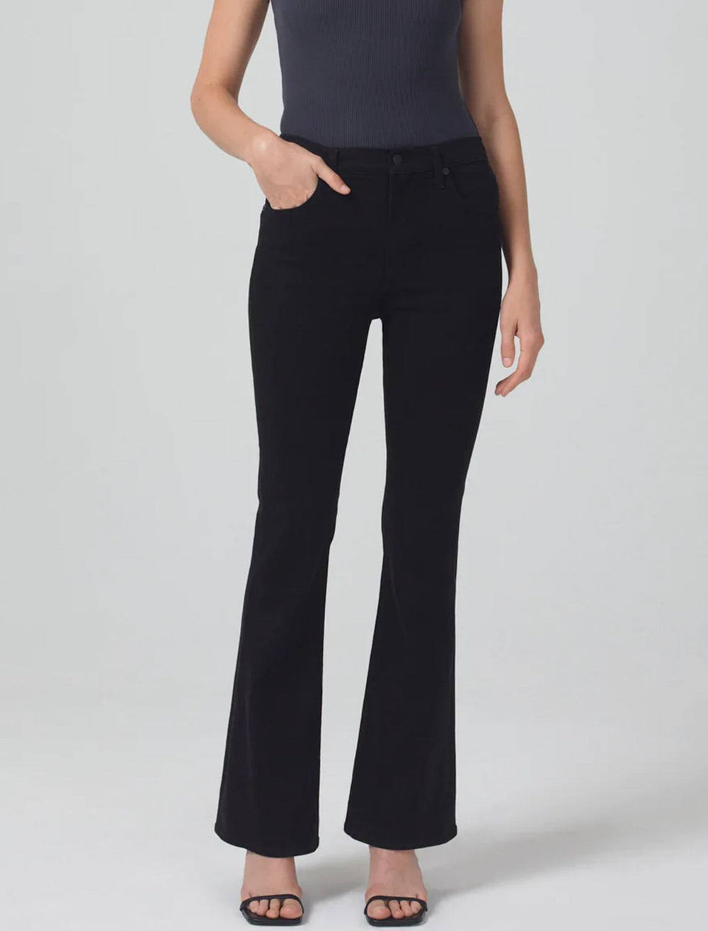 Model wearing Citizen of Humanity's lilah high rise bootcut in plush black.