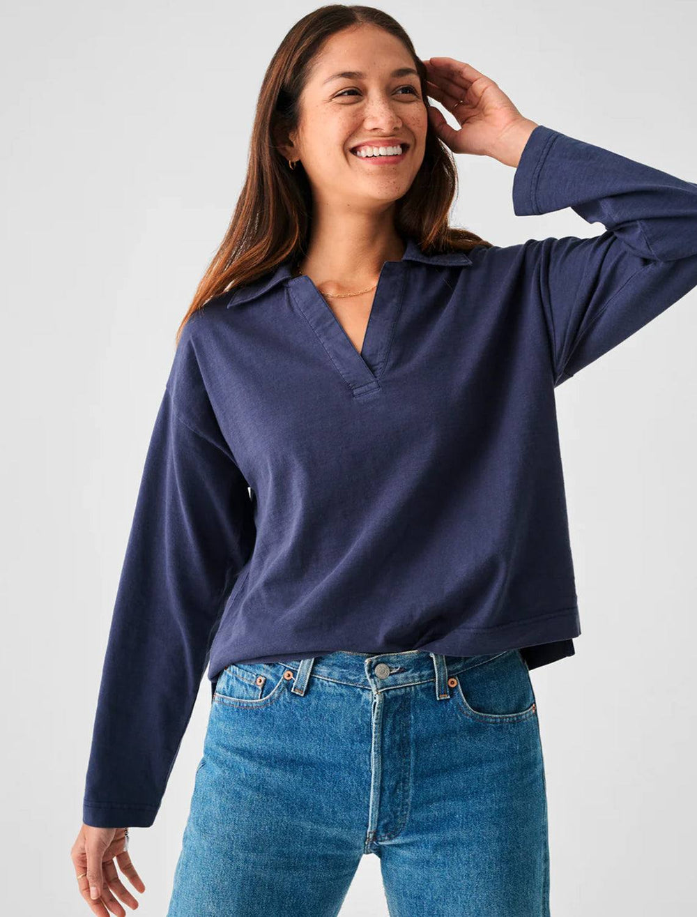 Model wearing Faherty's sunwashed polo in navy.