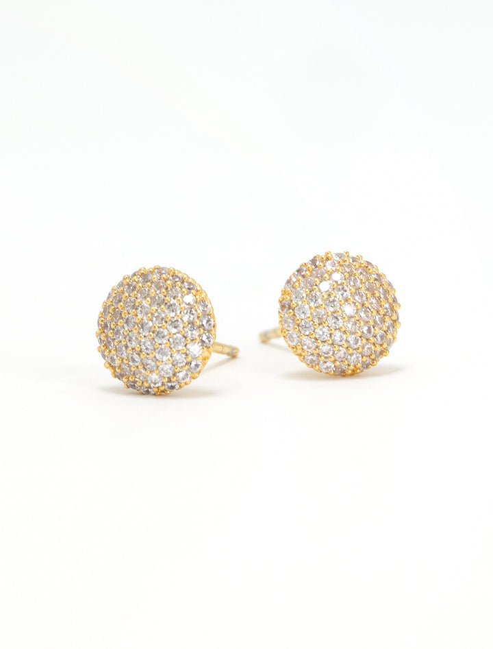 Close-up view of Tai's cz button studs in gold.