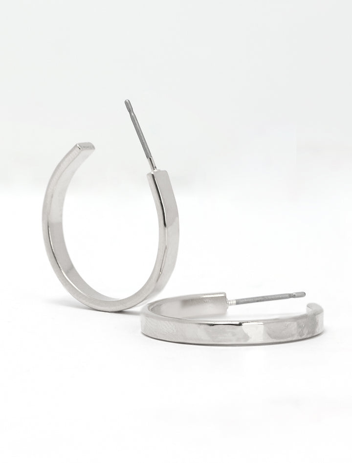 Close-up view of AV Max 3/4 inch hammered silver hoops