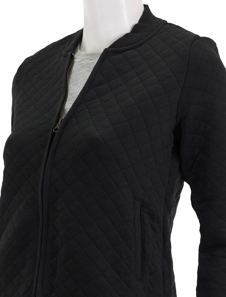 Close-up view of Marine Layer's corbet quilted bomber in black.