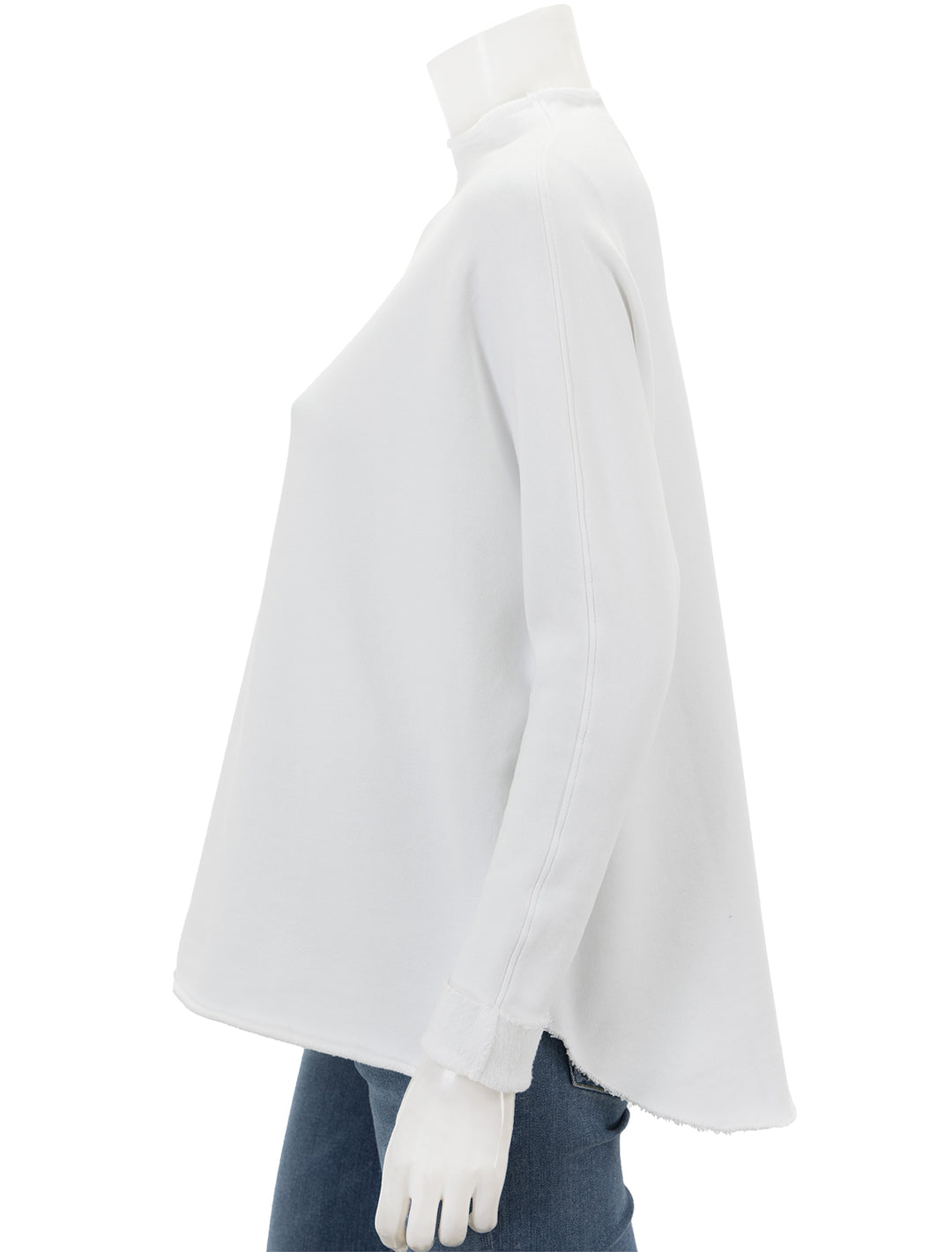 Side view of Frank & Eileen's funnelneck capelet in white.