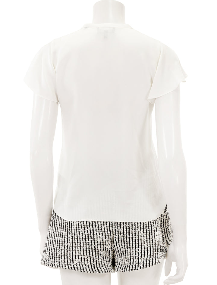 Back view of Theory's ruffle sleeve top in ivory.