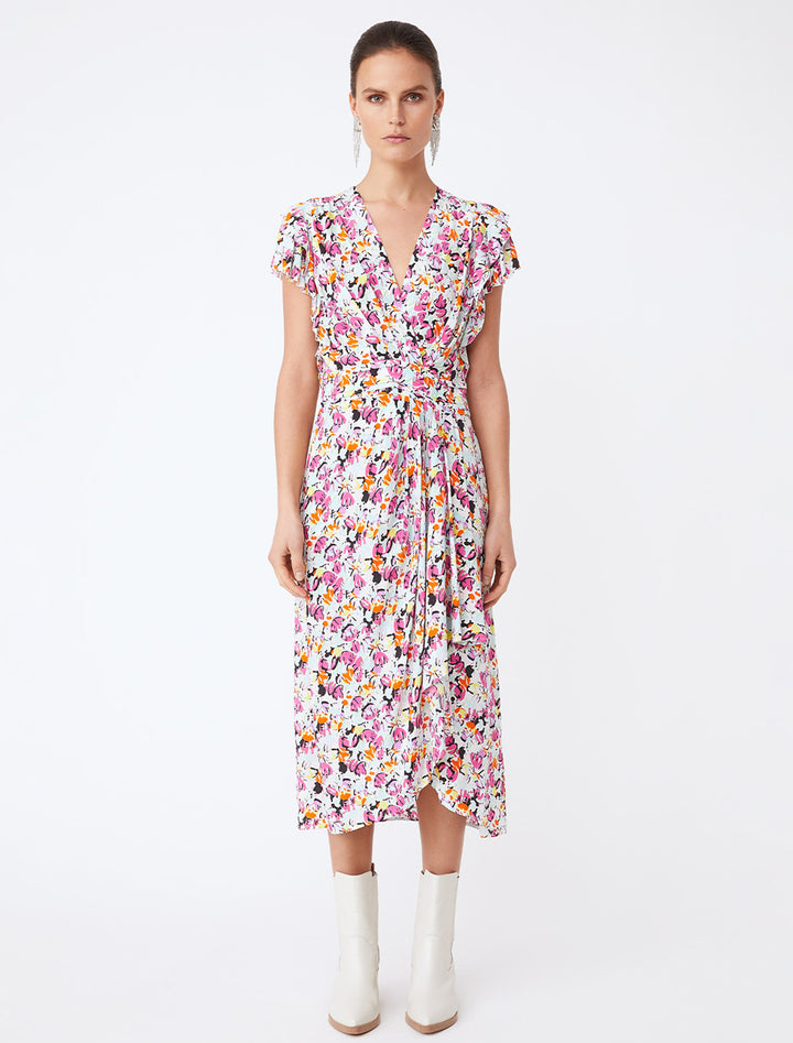 Model wearing Suncoo Paris' callista dress in fuchsia floral.