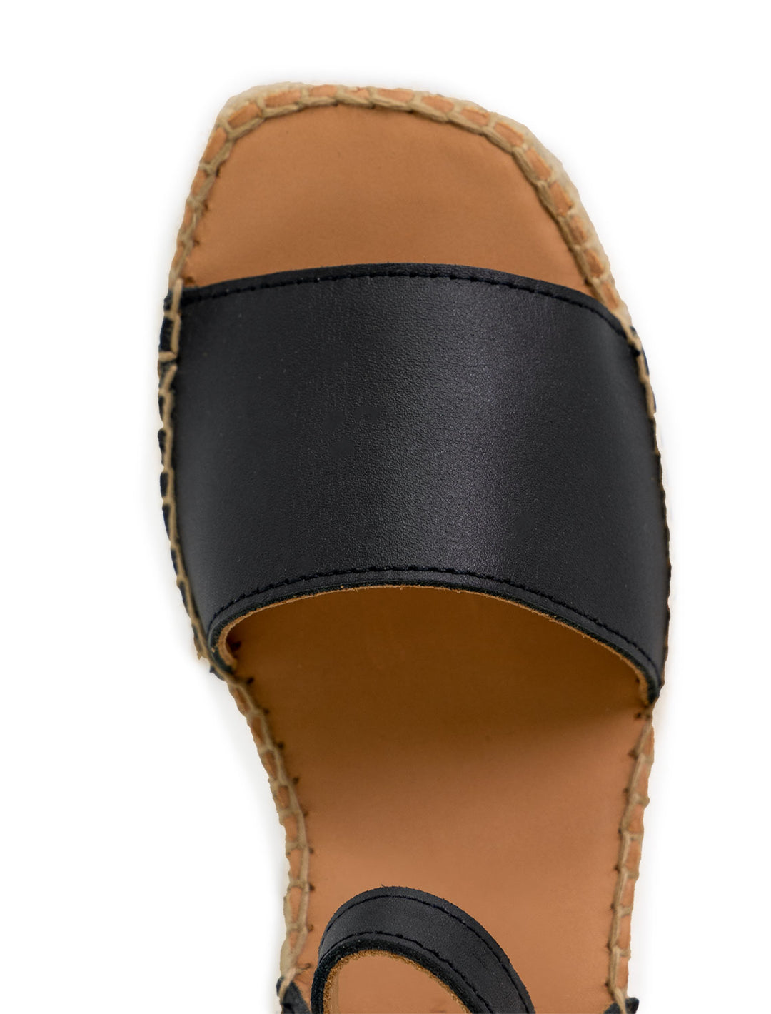 Close-up view of Naguisa's rall espadrille wedge in black.